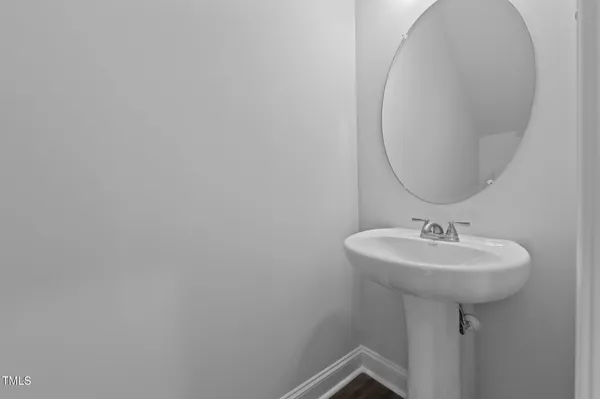 a bathroom with a sink a mirror and a toilet