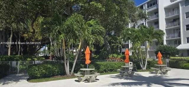 a view of a pathway with a flower garden