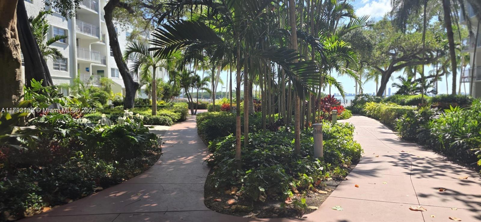 650 Northeast 64th Street, Unit G608 Miami, FL 33138 - Photo 12 of 31 a view of a pathway with a flower garden
