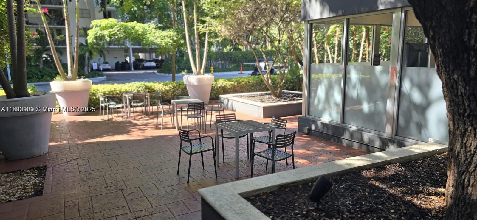 650 Northeast 64th Street, Unit G608 Miami, FL 33138 - Photo 14 of 31 a view of a porch with chairs and backyard