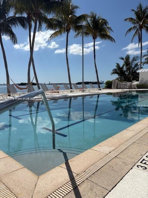650 Northeast 64th Street, Unit G608 Miami, FL 33138 - Photo 19 of 31 a view of swimming pool with a table and chairs