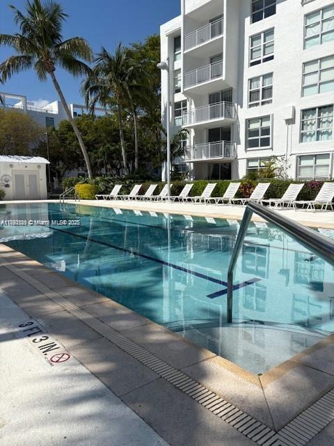 650 Northeast 64th Street, Unit G608 Miami, FL 33138 - Photo 20 of 31 a view of pool with lawn chairs and plants