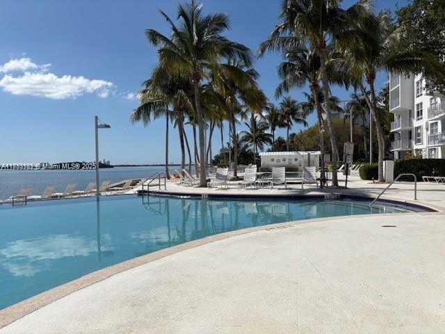 650 Northeast 64th Street, Unit G608 Miami, FL 33138 - Photo 21 of 31 a view of a swimming pool with a table and chairs