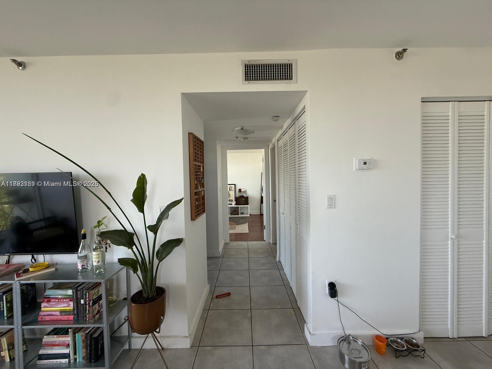 650 Northeast 64th Street, Unit G608 Miami, FL 33138 - Photo 29 of 31 a view of a hallway with workspace and entryway