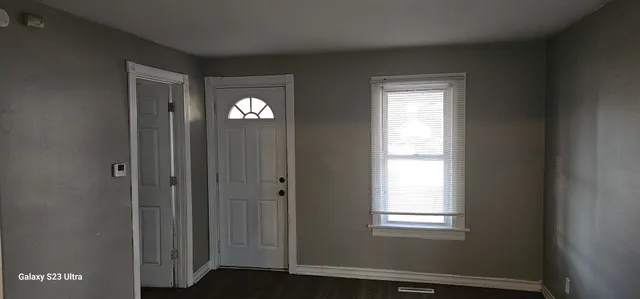a view of an entryway with wooden floor