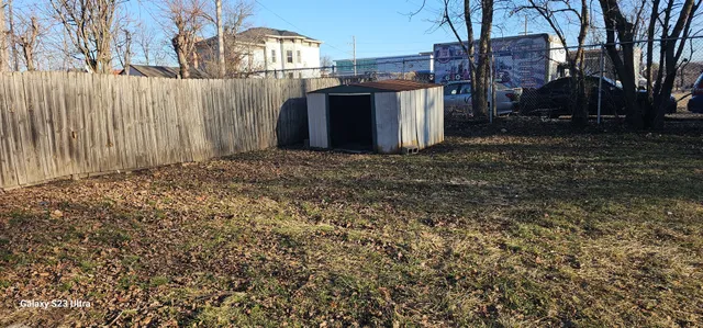 a view of a house with a backyard