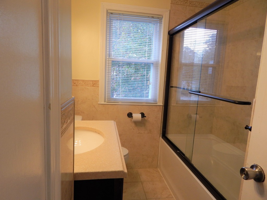 115 Desoto Road Boston, MA 02132 - Photo 12 of 21 a bathroom with a bathtub and shower