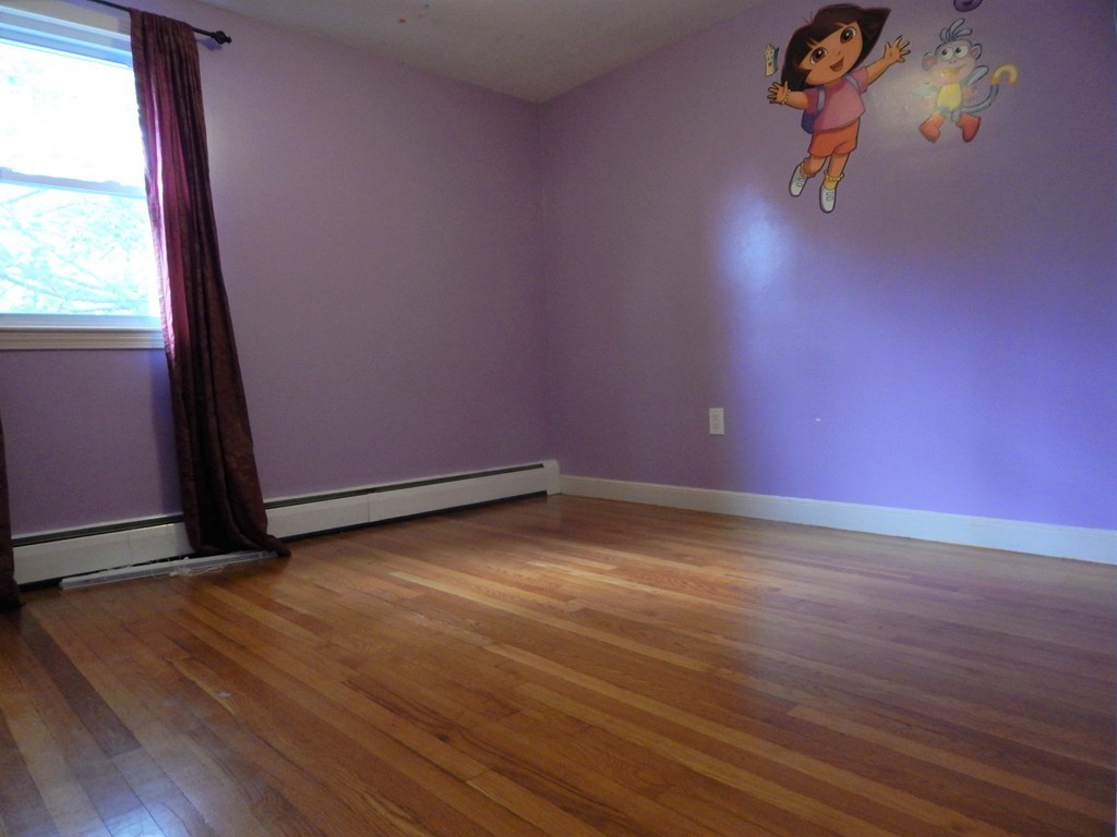 115 Desoto Road Boston, MA 02132 - Photo 16 of 21 an empty room with wooden floor and windows