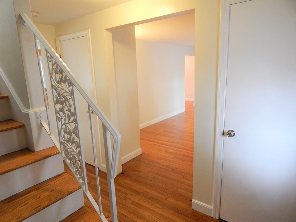 115 Desoto Road Boston, MA 02132 - Photo 17 of 21 a view of staircase with wooden floor and white walls