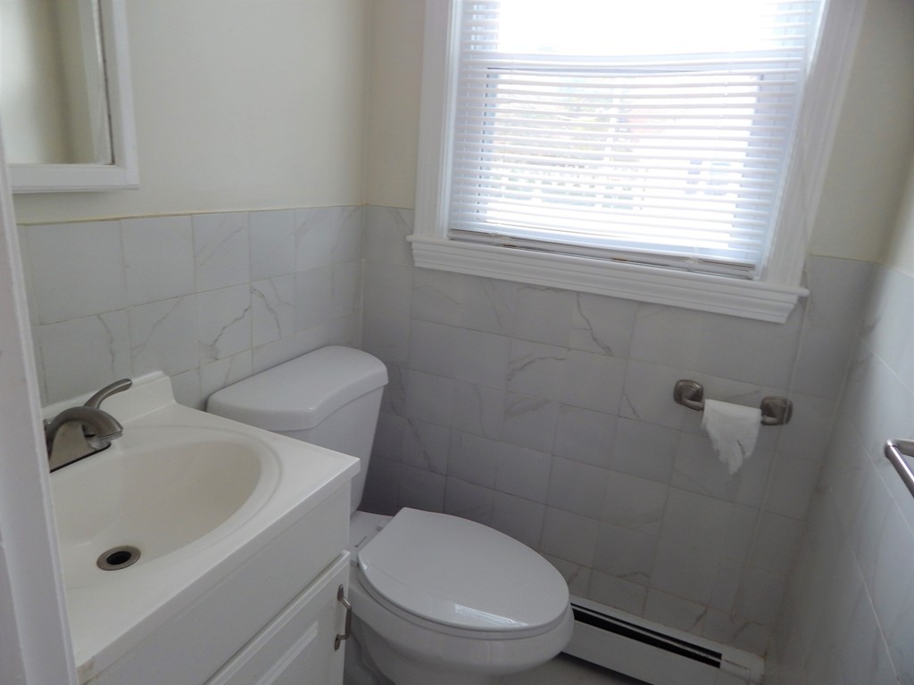 115 Desoto Road Boston, MA 02132 - Photo 8 of 21 a white toilet sitting next to a bathroom sink