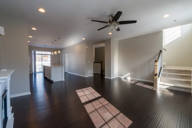 a view of a dining room with furniture a fireplace and wooden floor