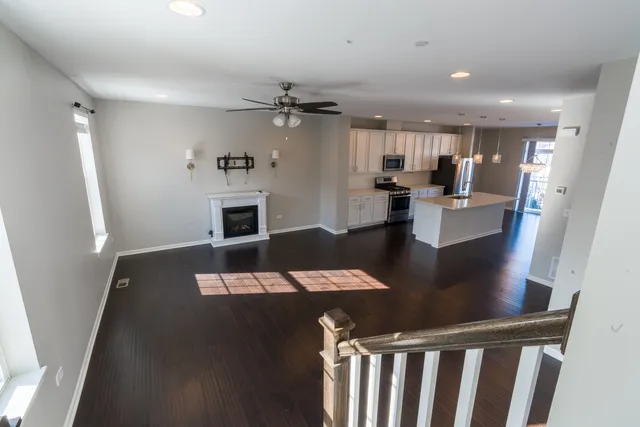a view of a hallway with windows and stairs
