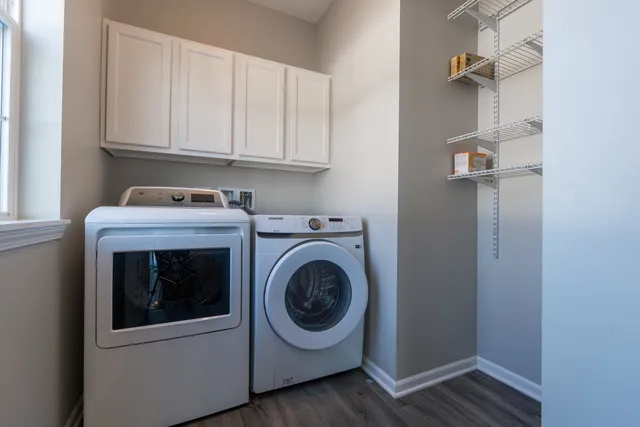 a view of a hallway with wooden floor and windows