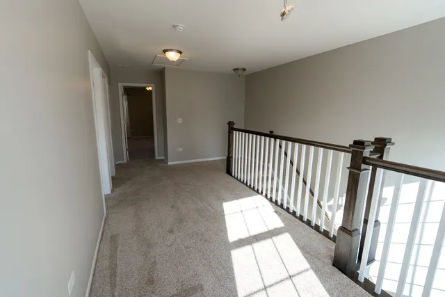 an empty room with closet and a chandelier fan