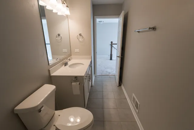 a white toilet sitting next to a bathroom sink