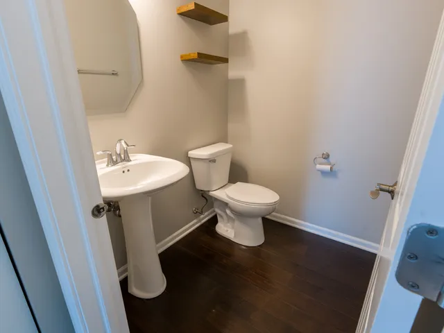 an empty room with wooden floor and a window