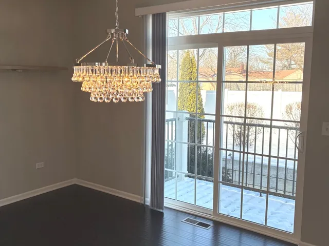 a view of a room with wooden floor staircase and a kitchen