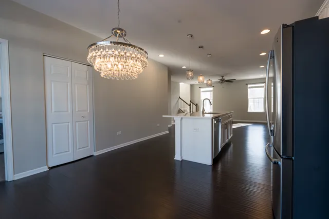 a view of empty room with fireplace and wooden floor