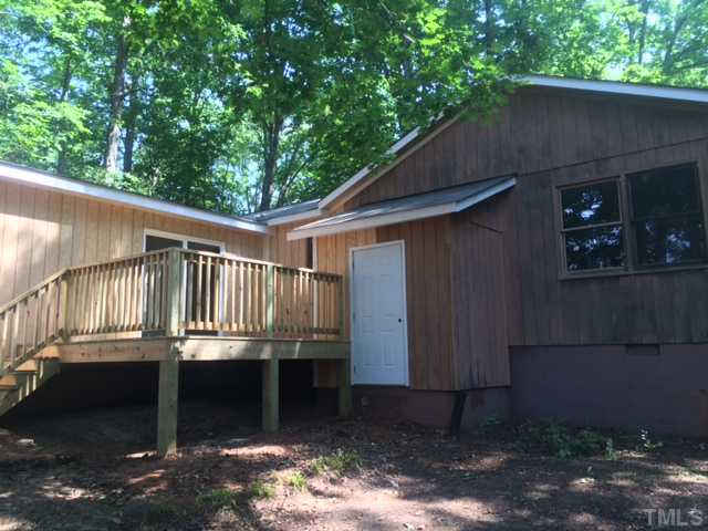 5617 Farmridge Road Raleigh, NC 27617 - Photo 3 of 3 a balcony with wooden floor and yard in the back