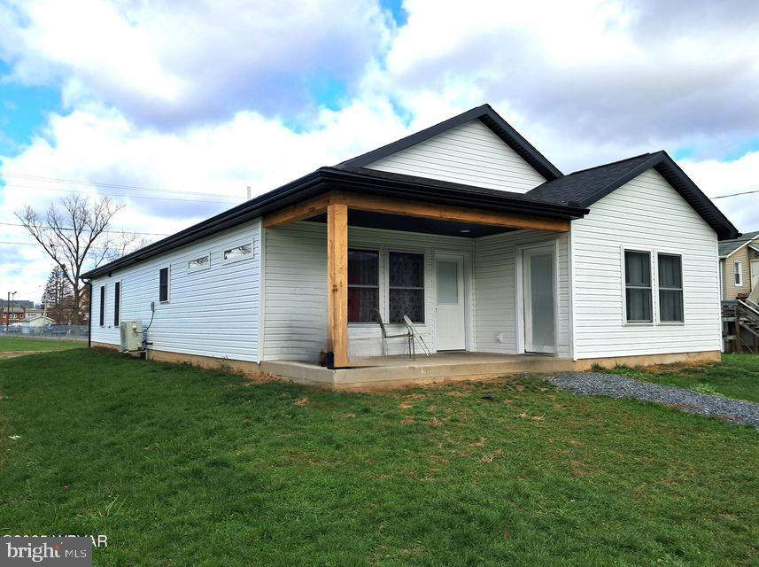 a front view of a house with yard and green space