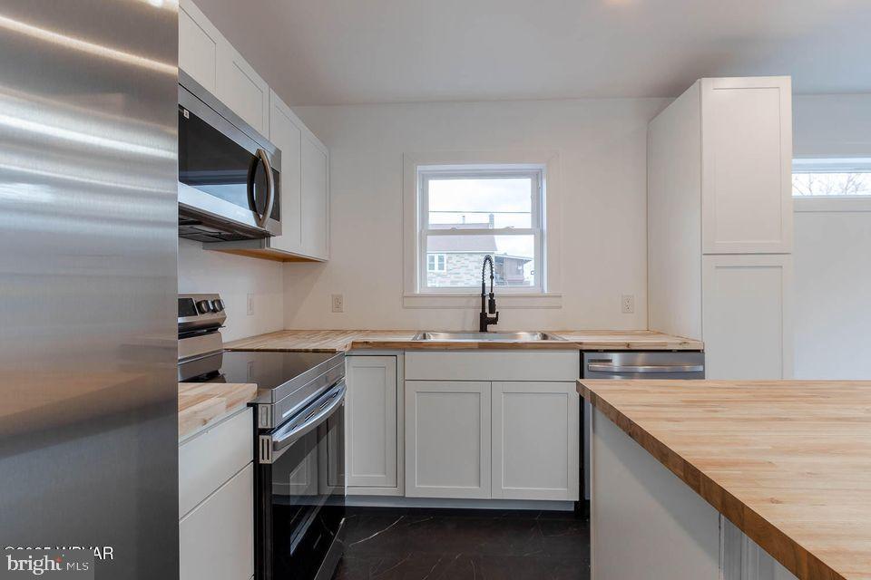 310-312 West Clinton Street Lock Haven, PA 17745 - Photo 17 of 30 a kitchen with a sink stove and microwave
