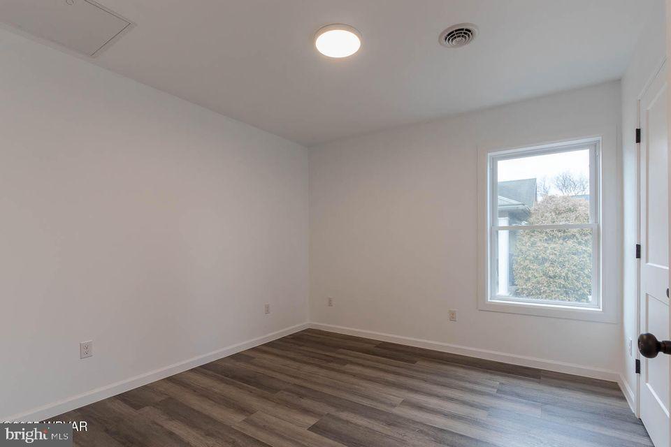 310-312 West Clinton Street Lock Haven, PA 17745 - Photo 8 of 30 an empty room with wooden floor and windows