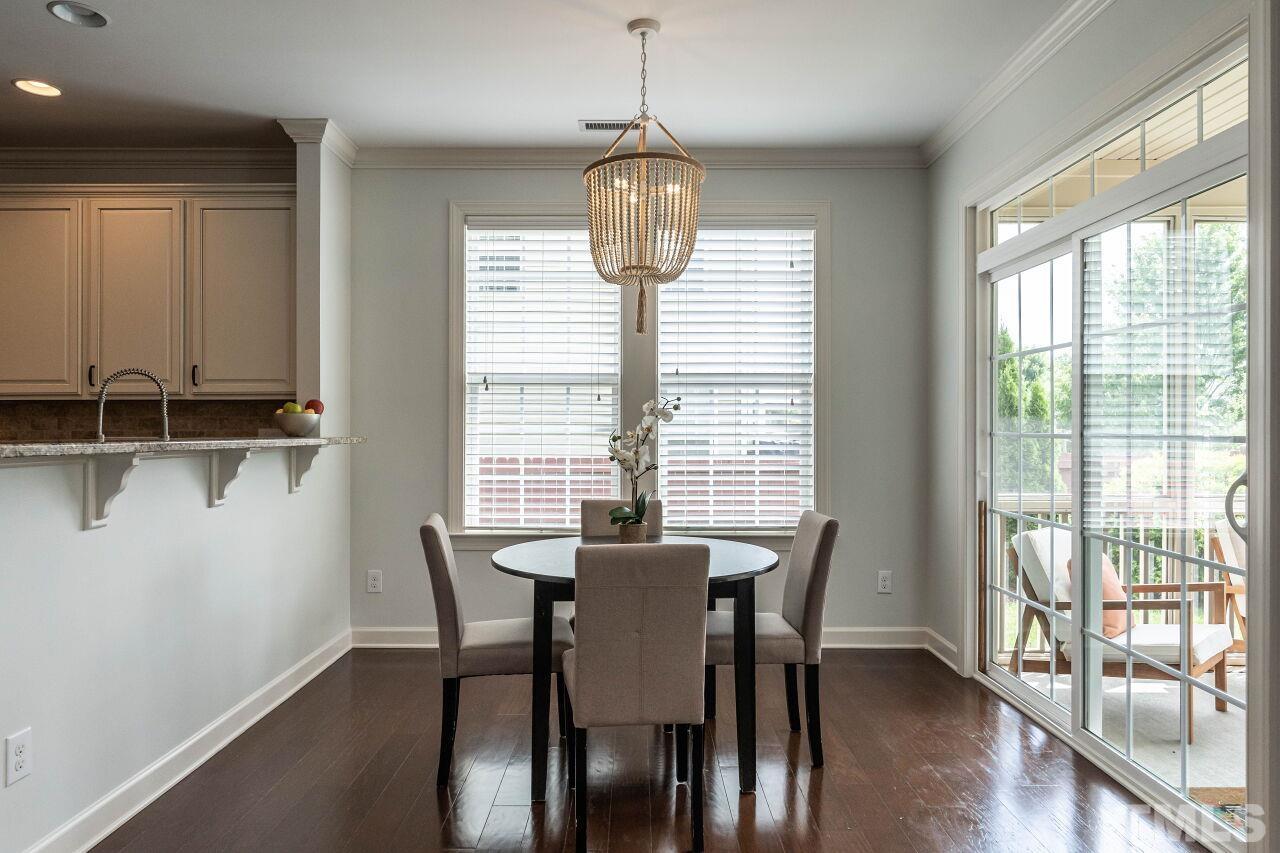 928 Palace Garden Way Raleigh, NC 27603 - Photo 12 of 40 a view of a dining room with furniture window and wooden floor