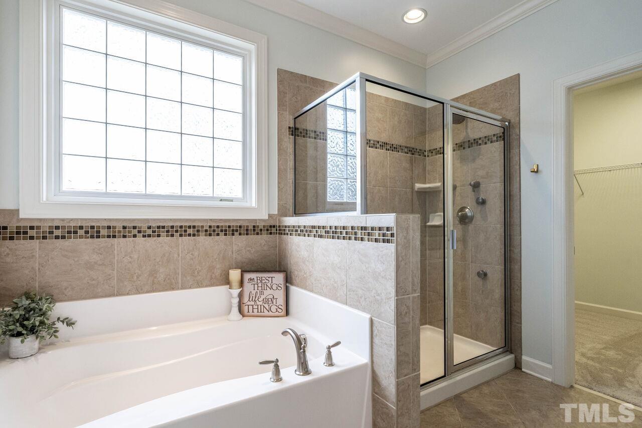 928 Palace Garden Way Raleigh, NC 27603 - Photo 21 of 40 a bathroom with a bathtub and shower