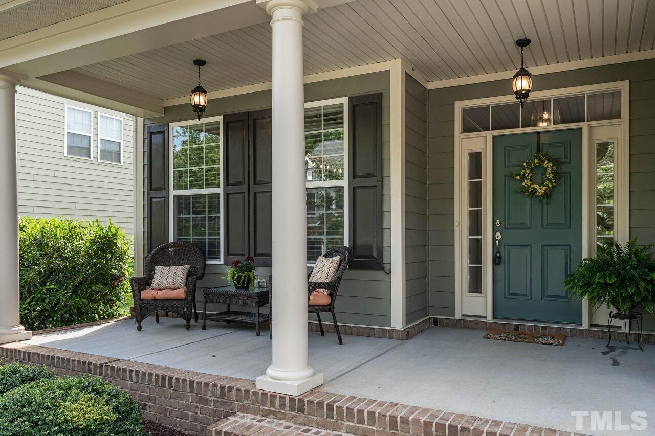 928 Palace Garden Way Raleigh, NC 27603 - Photo 3 of 40 a front view of a house with outdoor seating and a potted plant