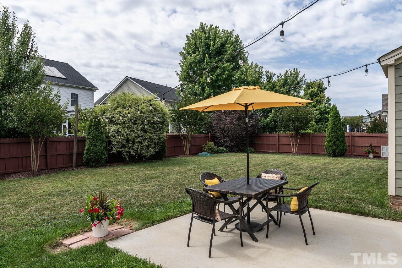 928 Palace Garden Way Raleigh, NC 27603 - Photo 31 of 40 a view of a backyard with furniture and a garden