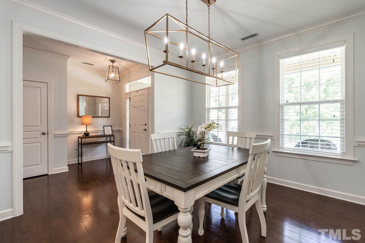 928 Palace Garden Way Raleigh, NC 27603 - Photo 6 of 40 a view of a dining room with furniture window and wooden floor