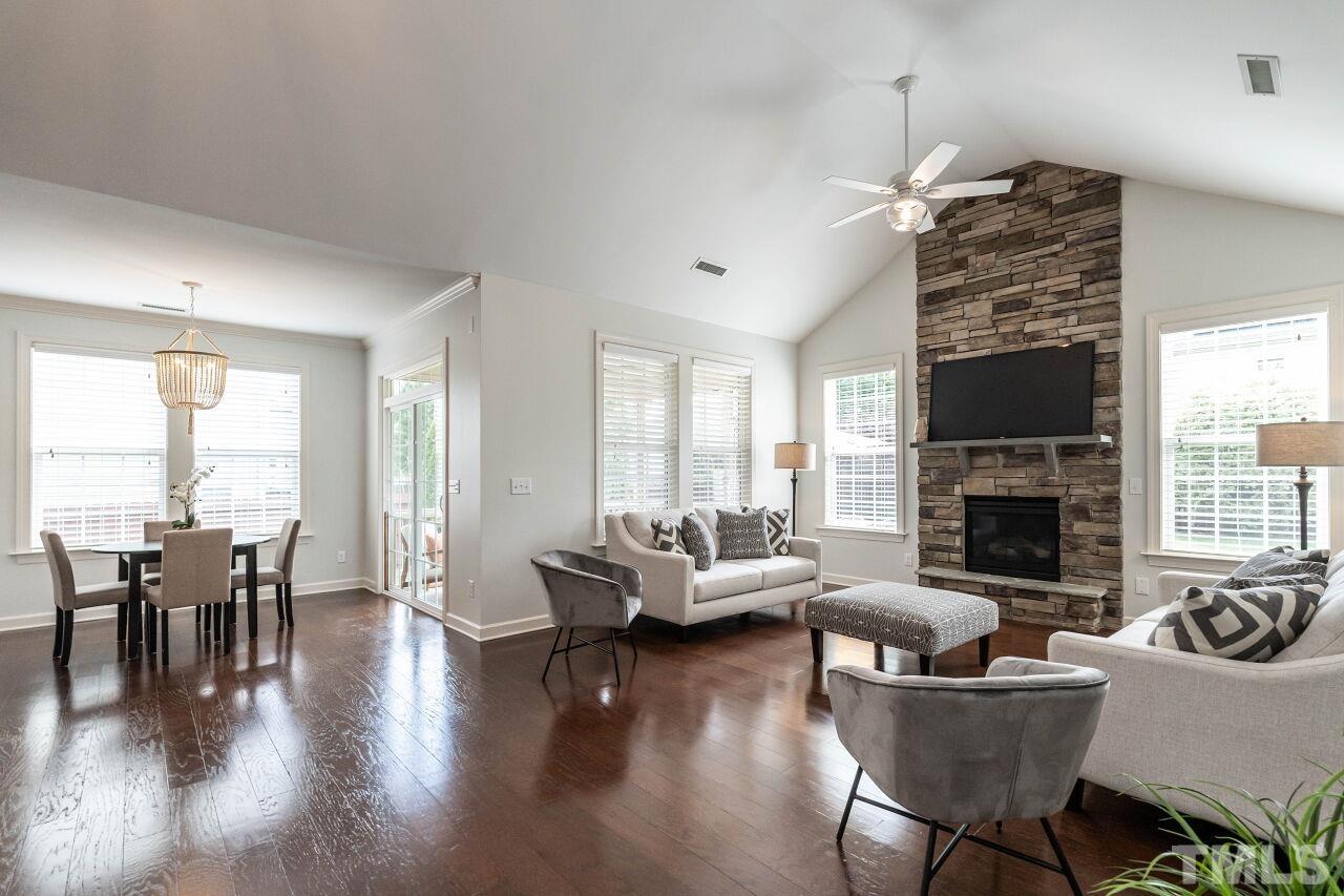 928 Palace Garden Way Raleigh, NC 27603 - Photo 9 of 40 a living room with furniture a fireplace and a large window