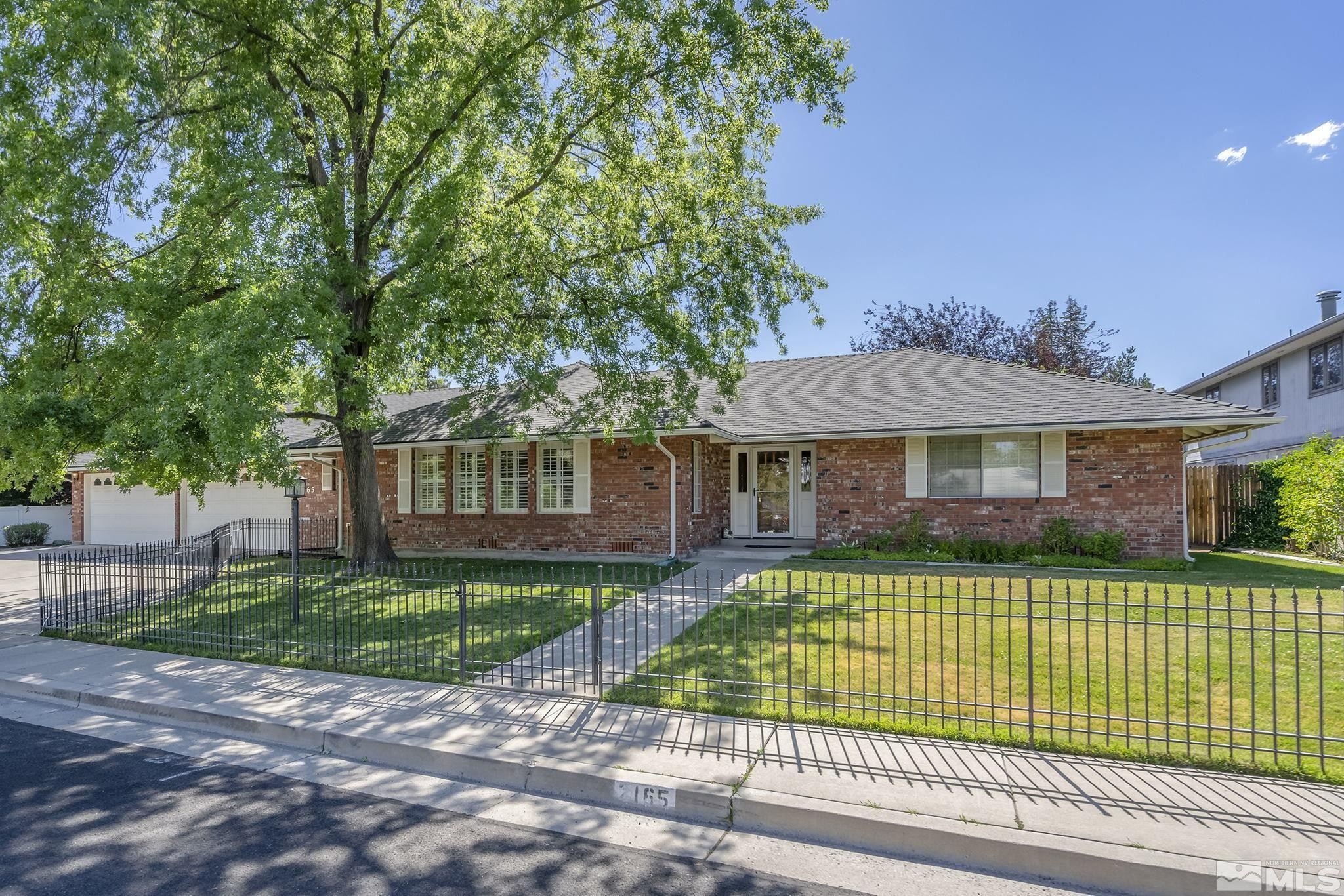 2165 Lander Street Reno, NV 89509 - Photo 2 of 26 a front view of a house with a garden