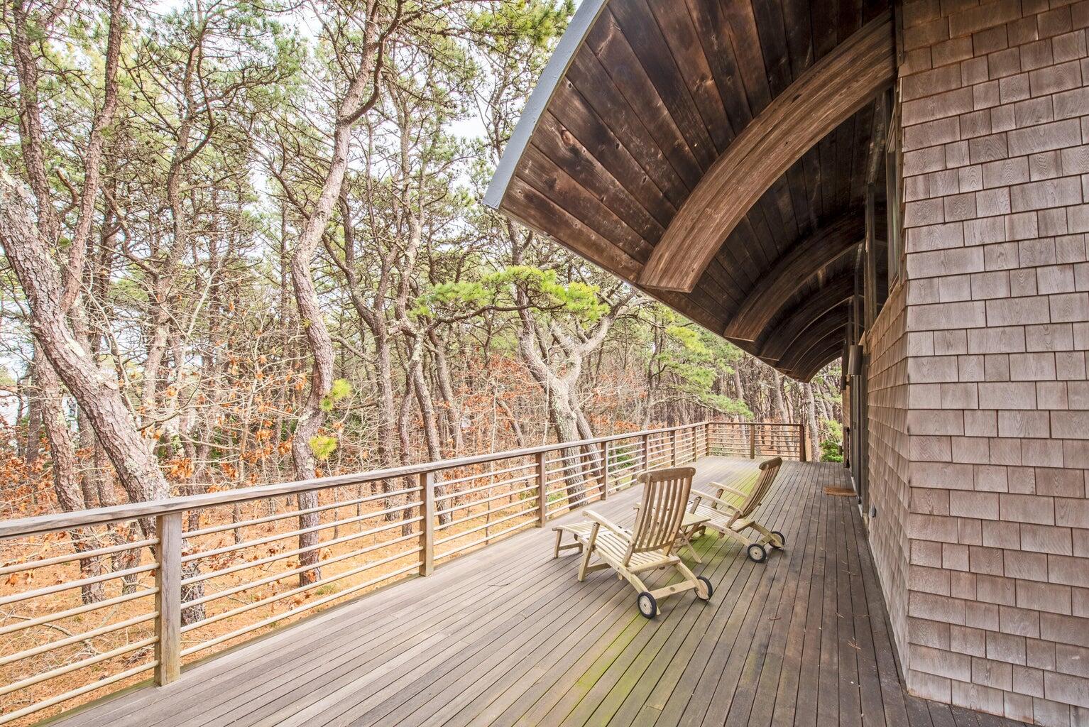 195 King Phillip Road Wellfleet, MA 02667 - Photo 3 of 62 a view of balcony with wooden floor and bench