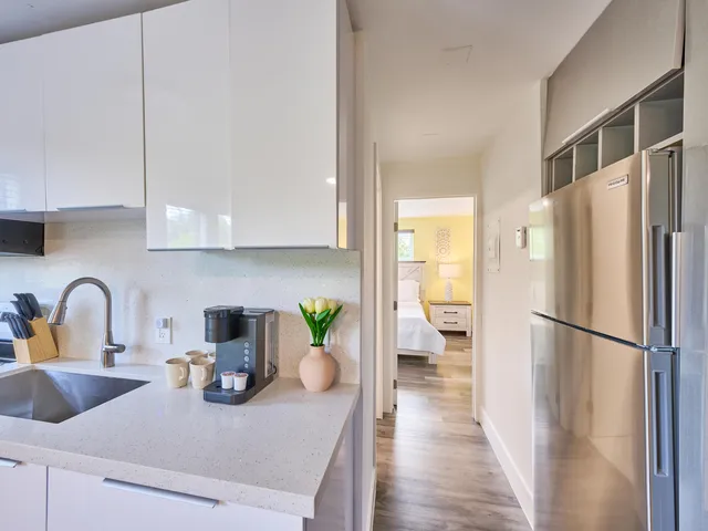 a kitchen with a refrigerator and a sink