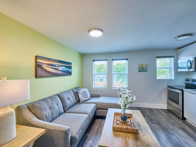 a living room with furniture fireplace and window