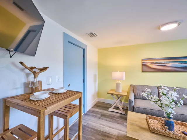 a living room with a table and chairs
