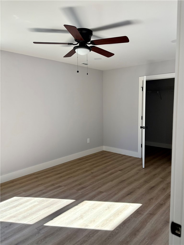 110 Ware Street Seneca, SC 29678 - Photo 11 of 24 This bright bedroom features durable flooring and a ceiling fan, offering both style and comfort.