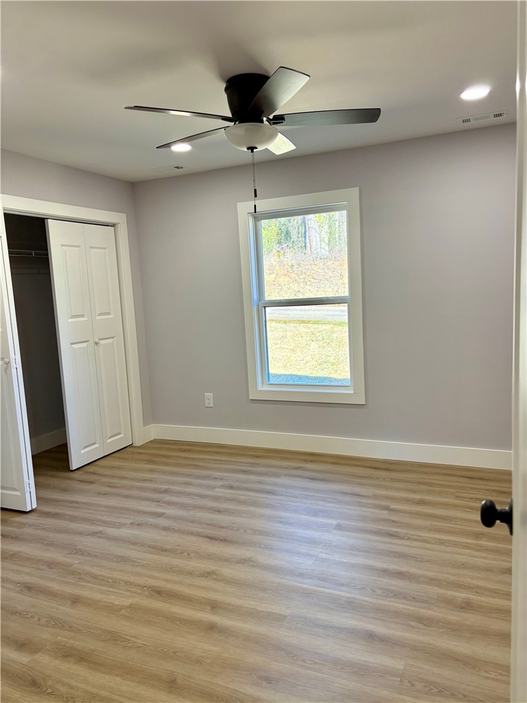 110 Ware Street Seneca, SC 29678 - Photo 15 of 24 This inviting bedroom features natural light and durable flooring, perfect for comfortable living.