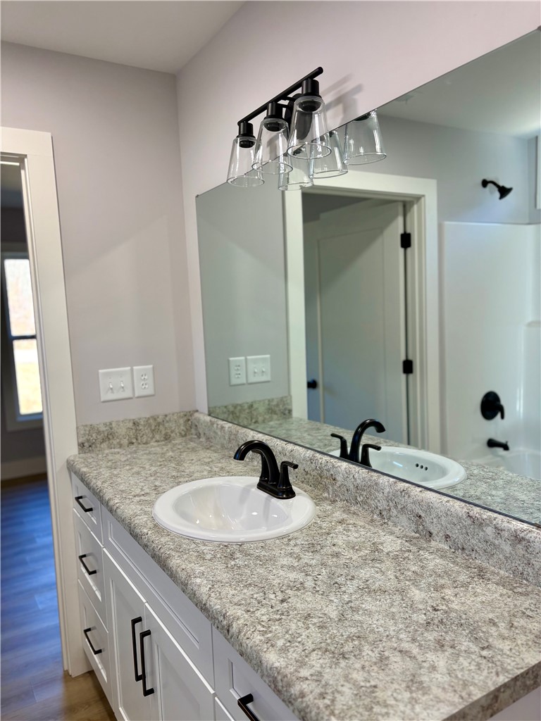 110 Ware Street Seneca, SC 29678 - Photo 18 of 24 This bright bathroom features a vanity with ample counter space and a large mirror.