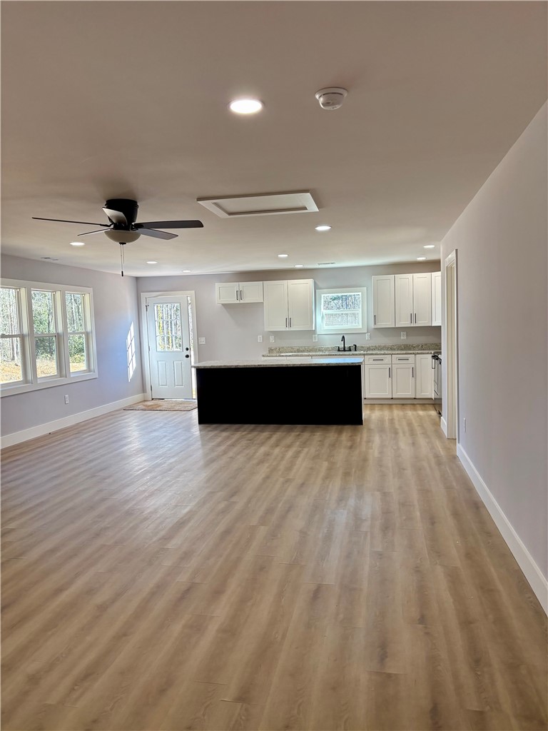 110 Ware Street Seneca, SC 29678 - Photo 20 of 24 This expansive open concept space features abundant natural light and seamless flow between living and kitchen areas.