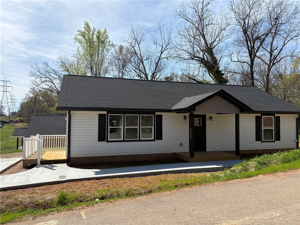 110 Ware Street Seneca, SC 29678 - Photo 22 of 24 This newly constructed home features a welcoming porch, a practical deck, and a classic shingle roof.