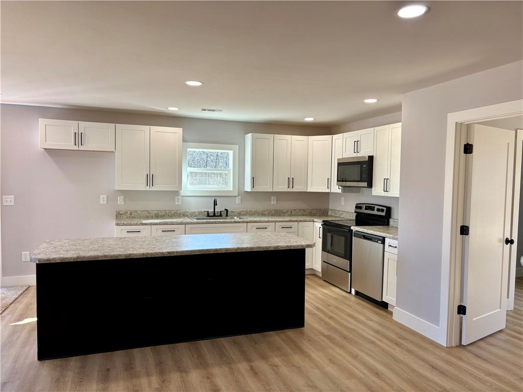 110 Ware Street Seneca, SC 29678 - Photo 5 of 24 This newly updated kitchen offers ample counter space, modern appliances, and a convenient island.