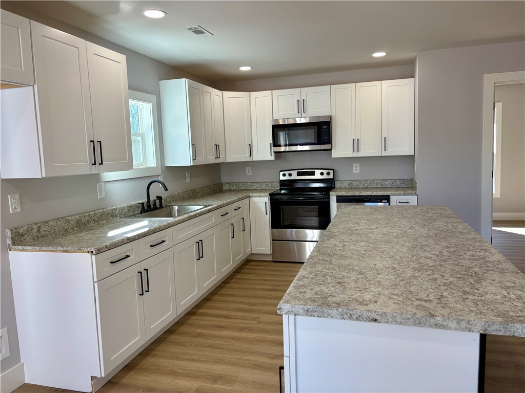 110 Ware Street Seneca, SC 29678 - Photo 7 of 24 Bright and open kitchen with ample counter space and modern appliances for culinary pursuits.