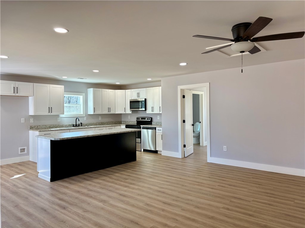 110 Ware Street Seneca, SC 29678 - Photo 9 of 24 This kitchen showcases a central island and modern finishes, perfect for culinary endeavors.