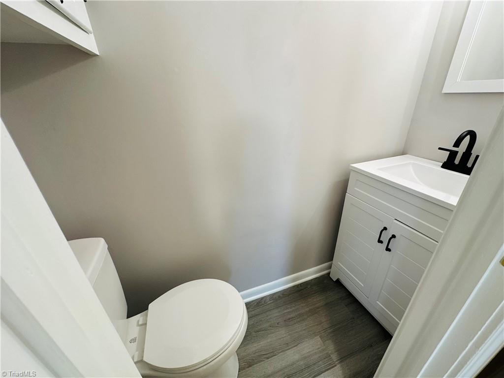 3028 Sparta Road North Wilkesboro, NC 28659 - Photo 18 of 24 New vanity and commode, faucets, flooring, paint and llighting.