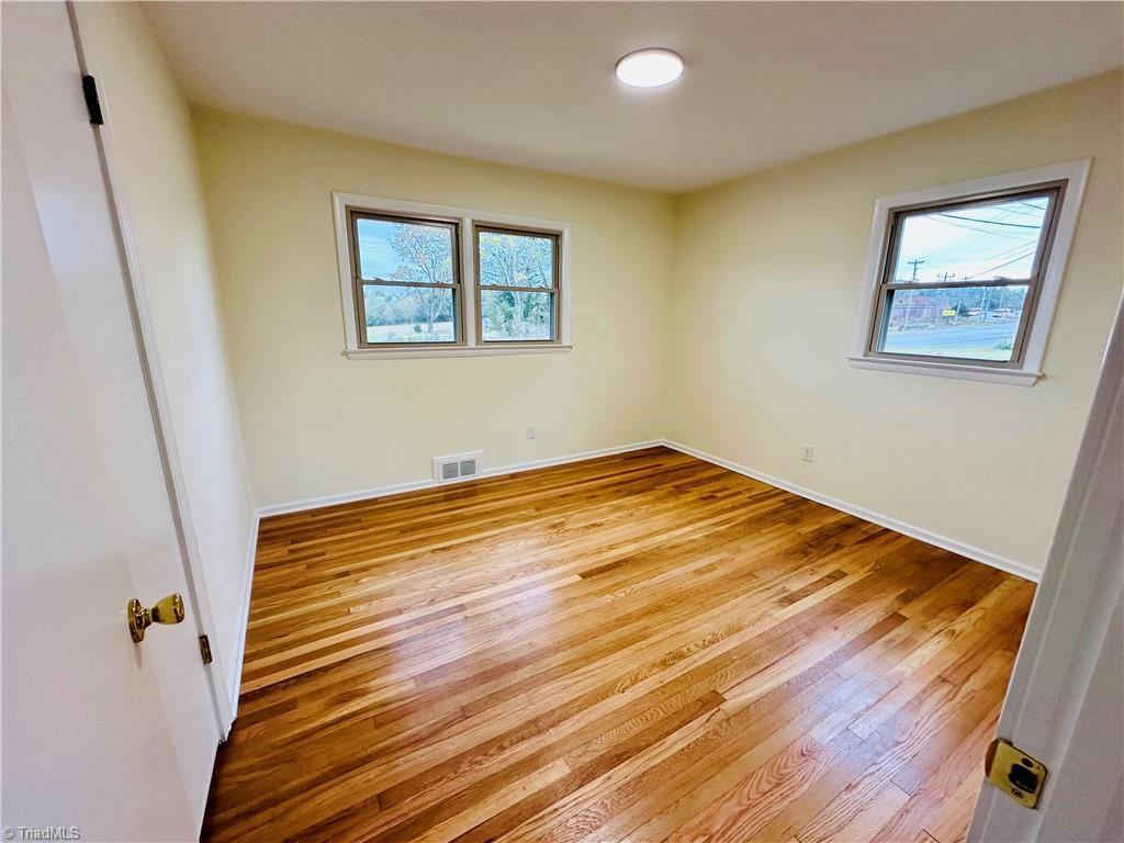 3028 Sparta Road North Wilkesboro, NC 28659 - Photo 20 of 24 Bedroom #2 with newly finished hardwood flooring and paint.