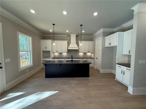 a kitchen with granite countertop white cabinets and white appliances