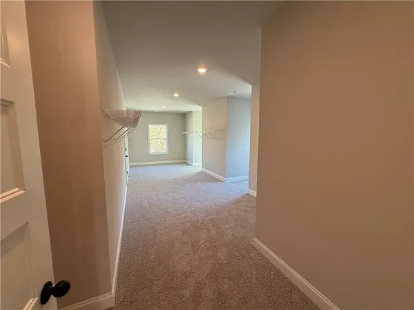 a view of hallway and closet
