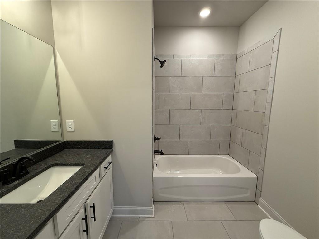 3844 Cheyenne Lane Jefferson, GA 30549 - Photo 32 of 36 a bathroom with a granite countertop sink and a bathtub